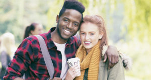 Teen boy and girl with a coffee smile for photo
